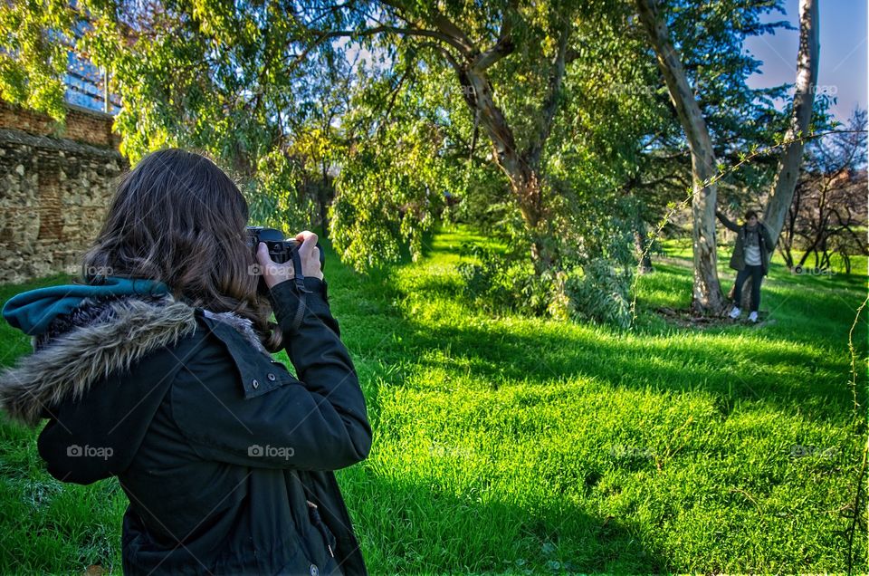 Woman taking photograph of a man with camera