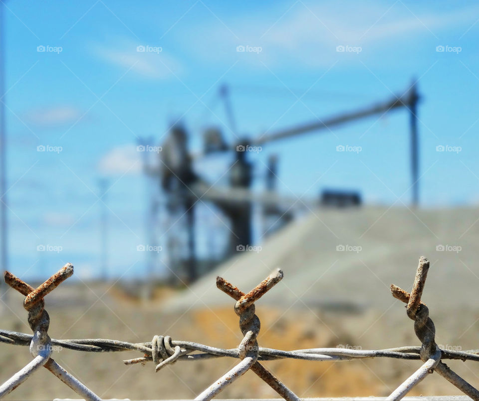 Barb wire fence at an industrial site