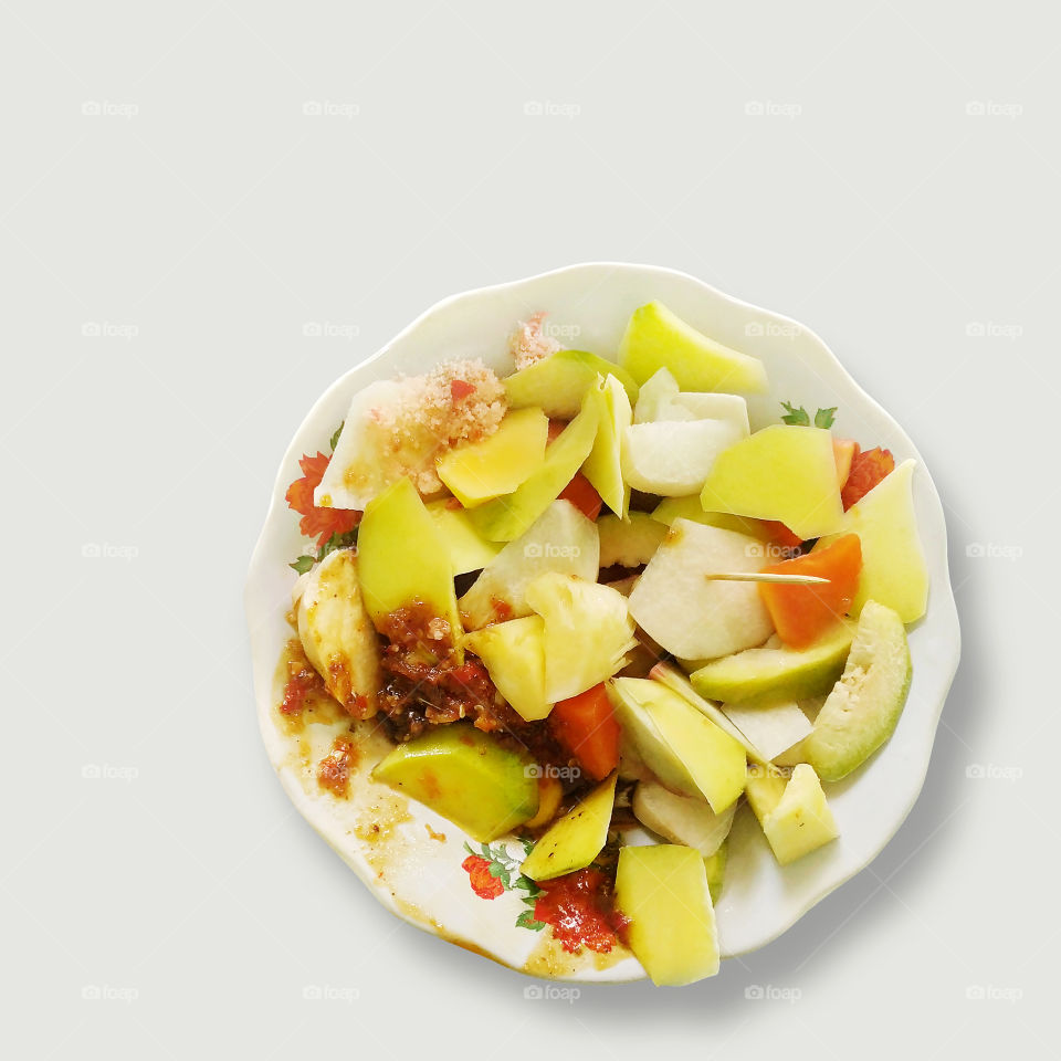 sliced fruit with red javanese sugar and chili sauce that called rujak