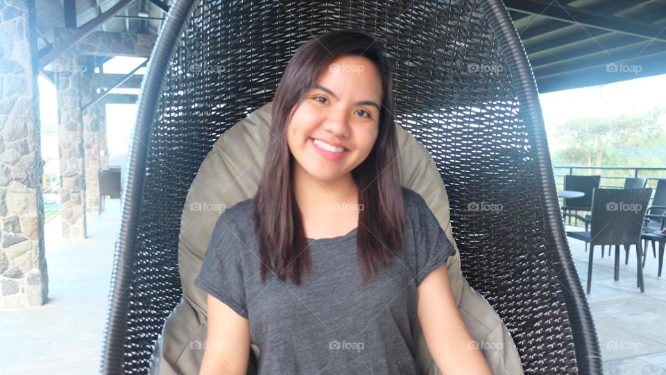 Filipino sitting on a chair