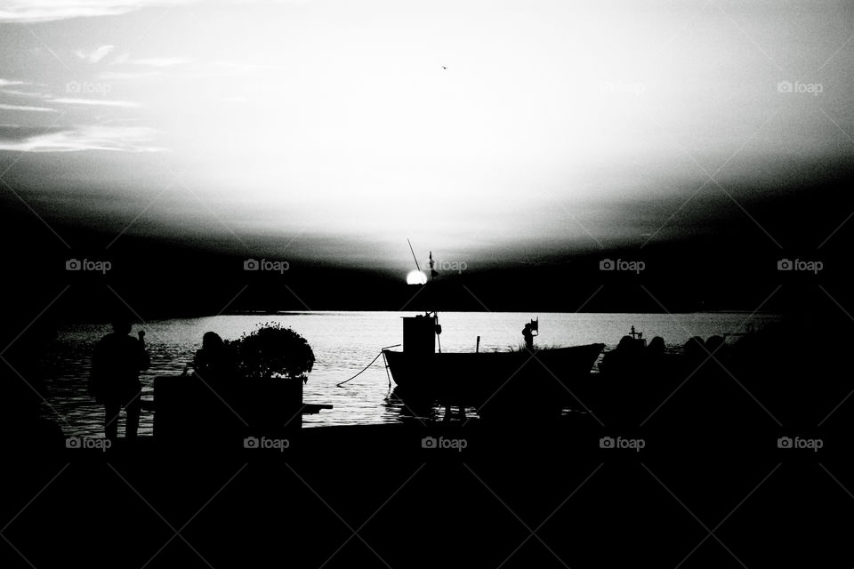 Fisherman at sunset. Black and white rendering