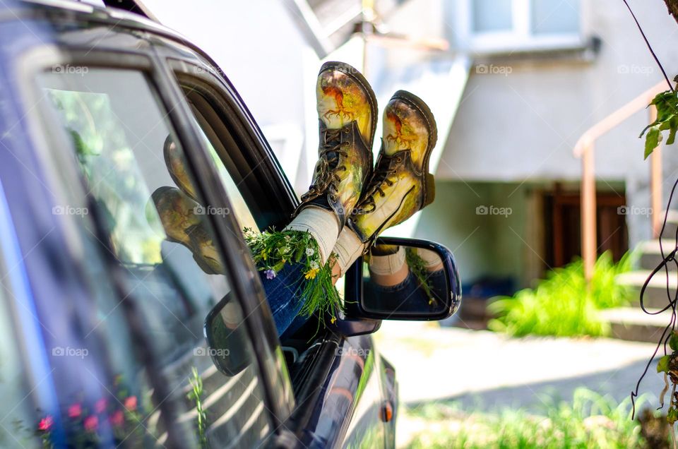 What's that doing here 😃? Woman Lying in Car With her Feet Out of Car Window. She Have Flowers Inside the Boots