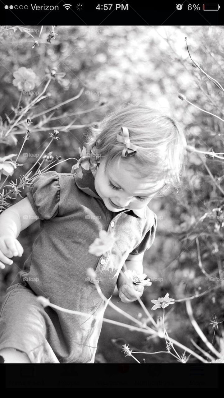 Little girl in wild flower patch in black and white 