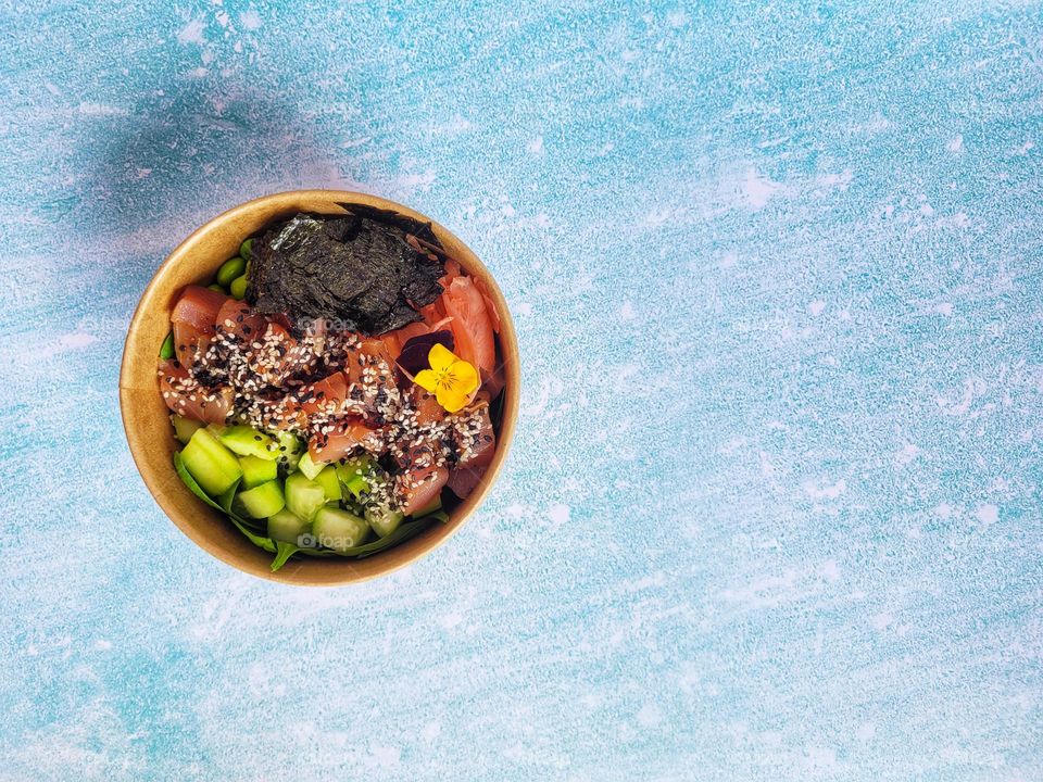 Food concept.  Wok boxes with sea food, shrimps,  edamame and vegetables close up. Blue background