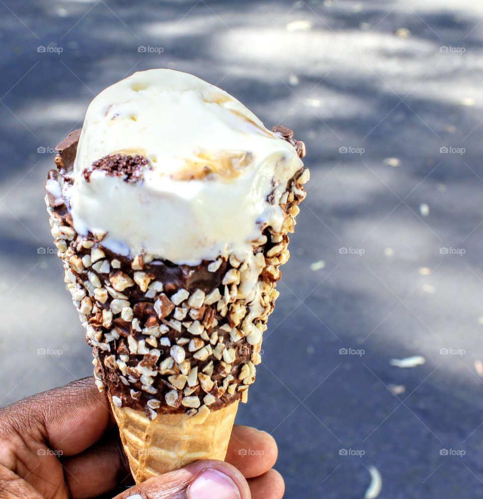Delicious ice cream cone with topping