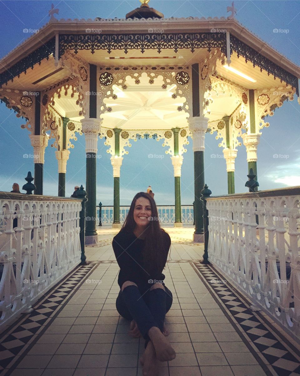 Woman sitting at Victorian Bandstand, Brighton
