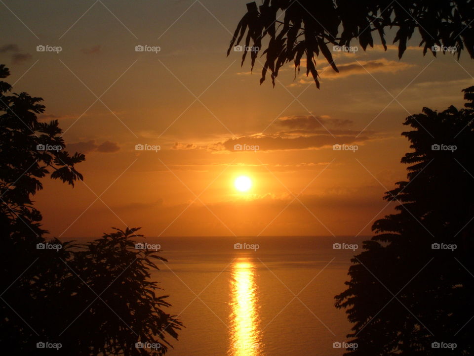 Beautiful shades of orange sunset glazing the peaceful, calm, refreshing and breath taking  Caribbean sea