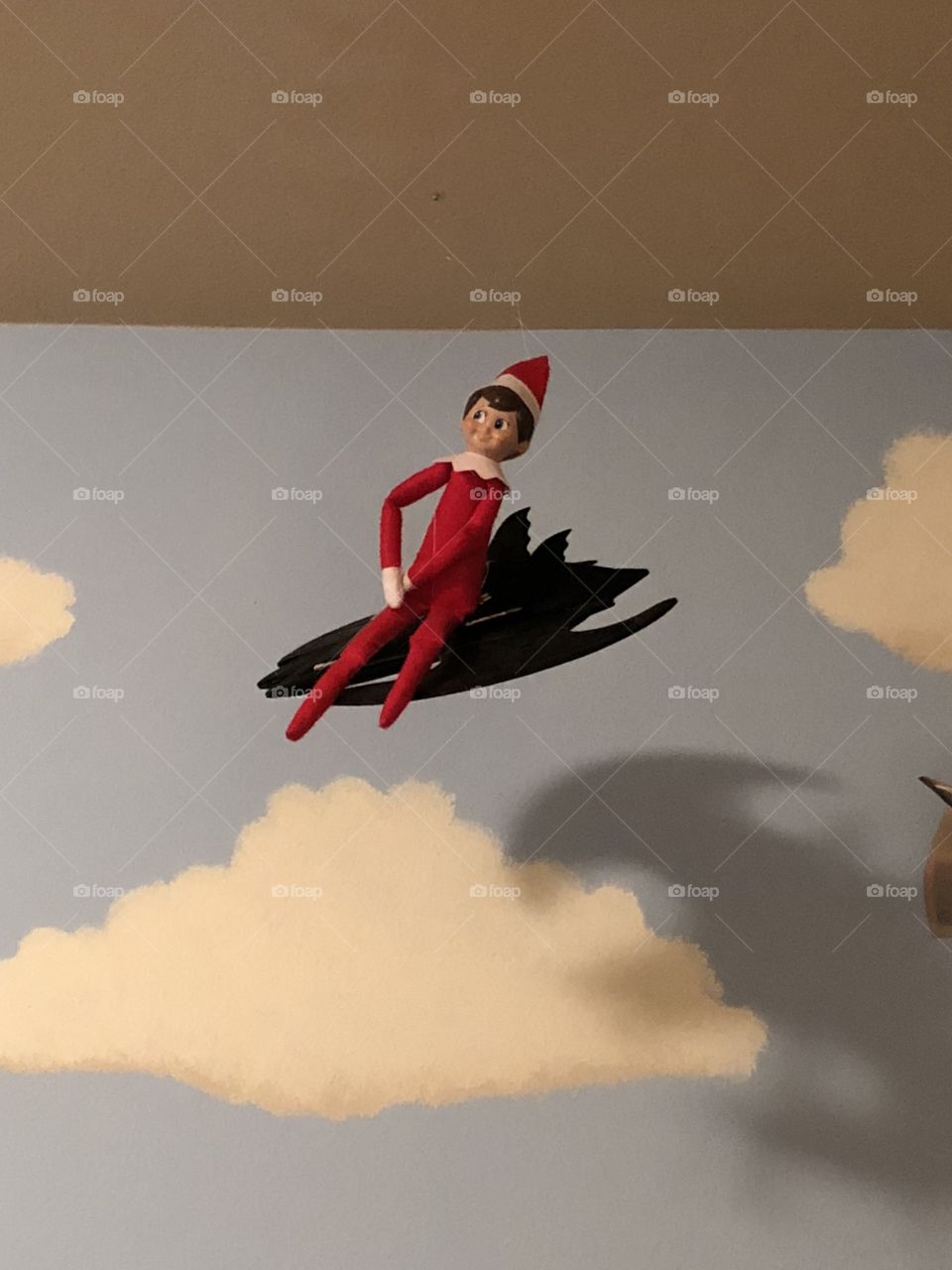 Elf on the shelf decided to hitch a ride with Batman to the north pole!  A child’s Eld on the Shelf sits on his toy Bat plane hanging from his rooms ceiling.
