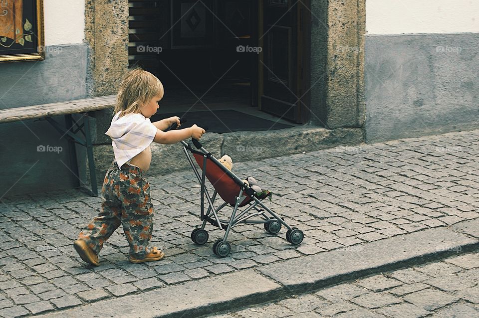 Girl with stroller going for a walk