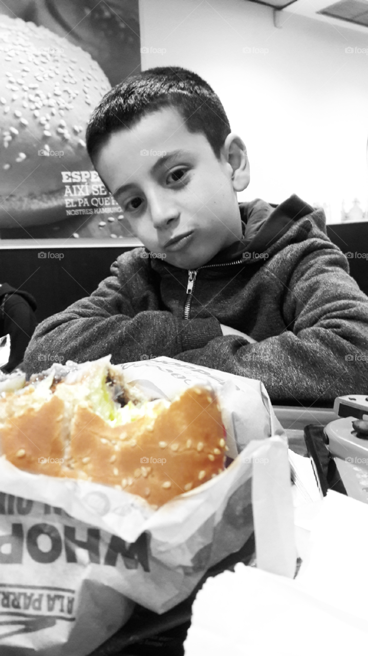 Boy looking at burger