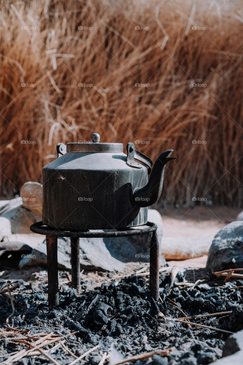 Metallic kettle on the open fire 