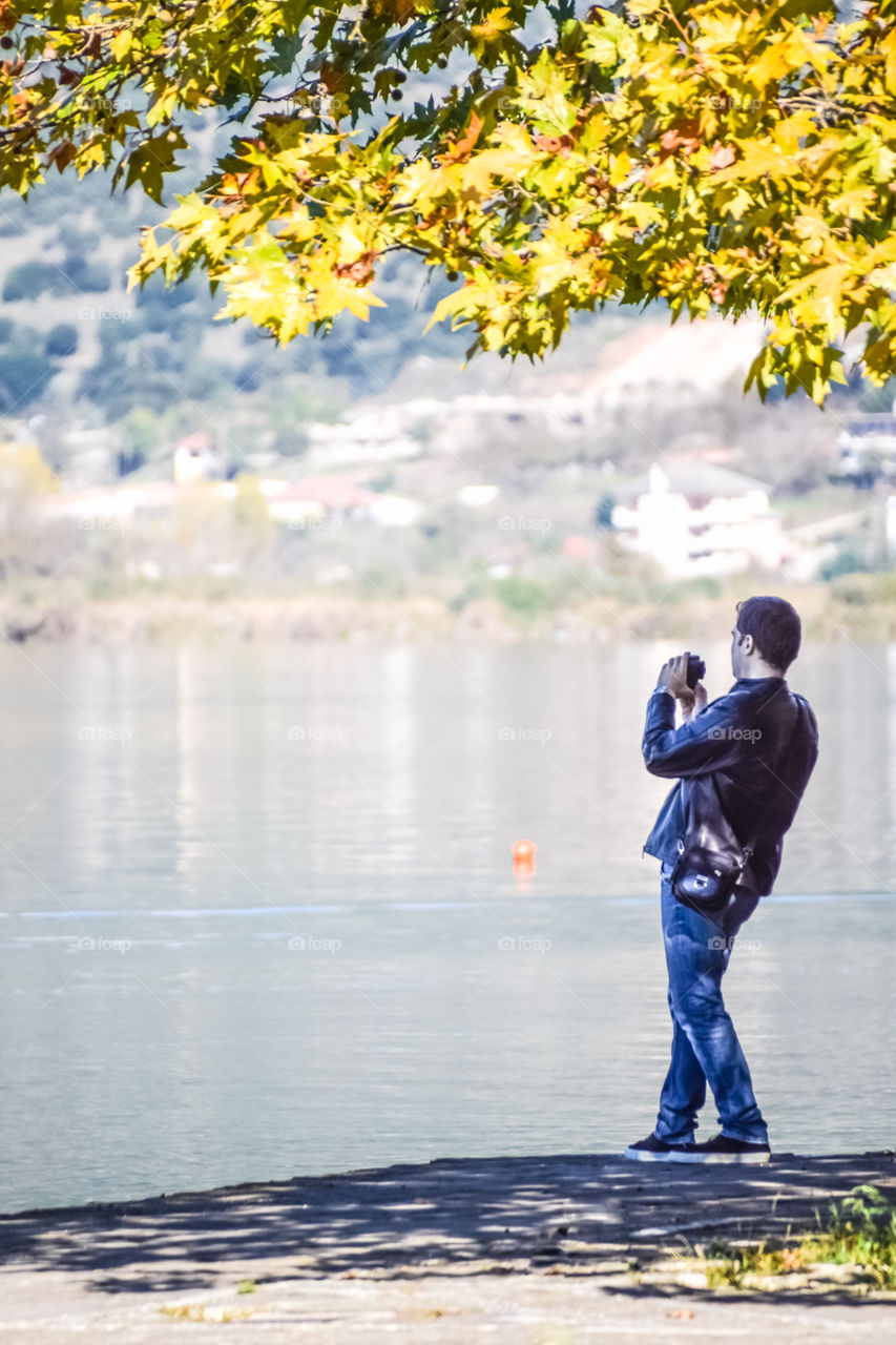 Young Man Traveler Photographing Nature Landscape
