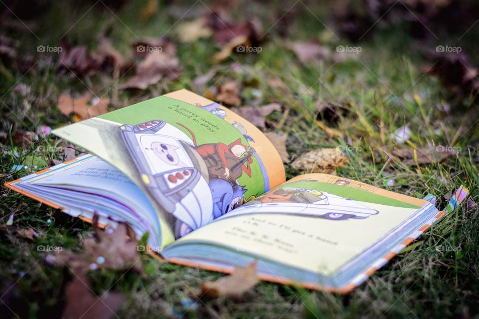 An open book laying in the grass