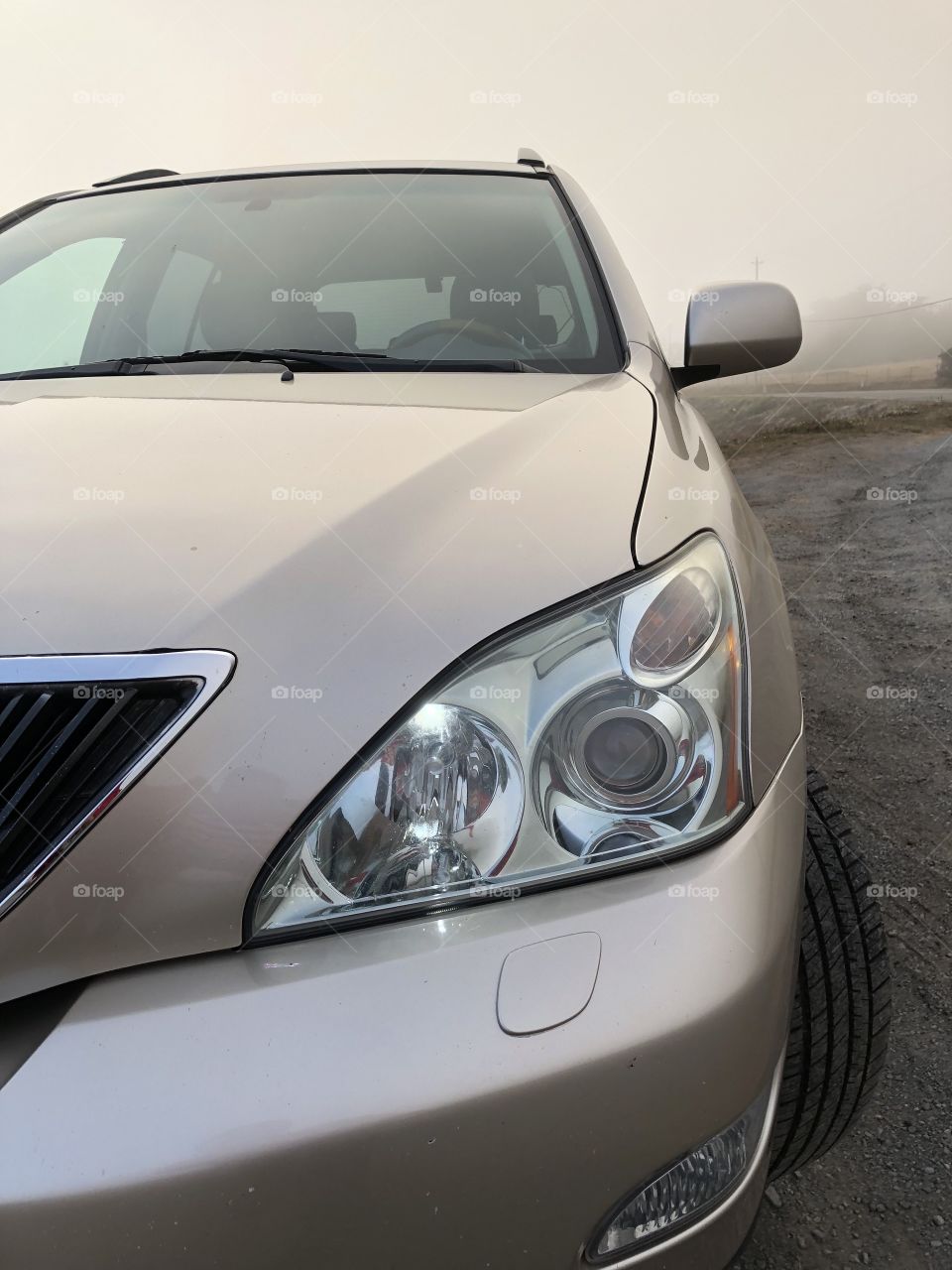 Lexus RX 350 on the beach on foggy weather 