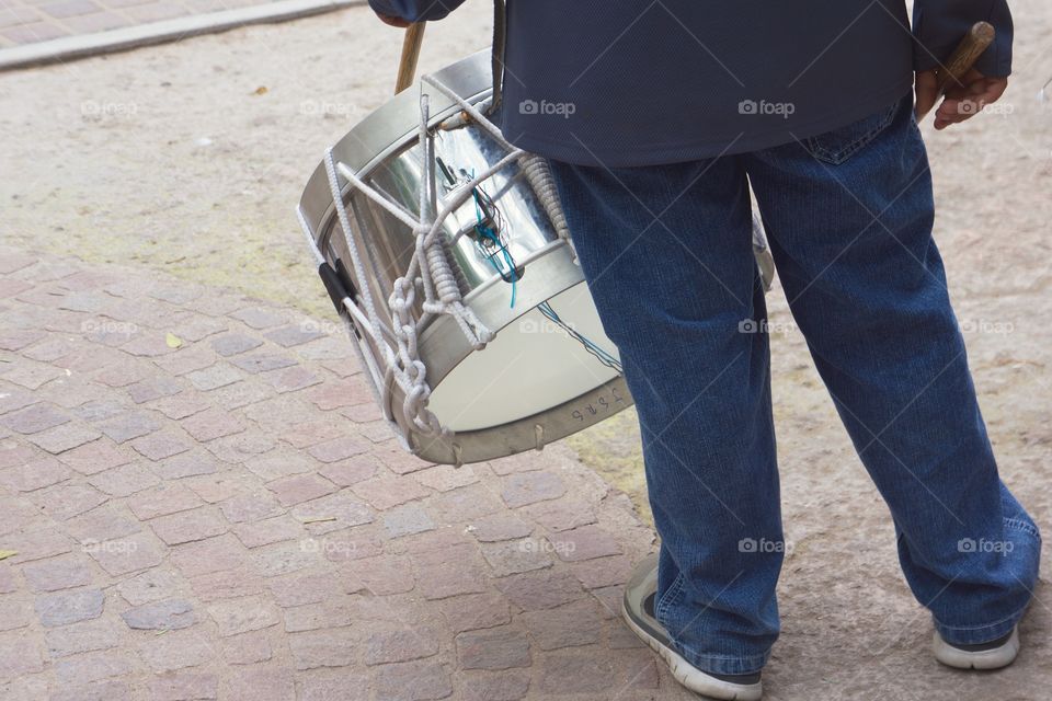 A boy, a member of a school marching band practices his rhythms in a park in San Miguel de Allende , Mexico