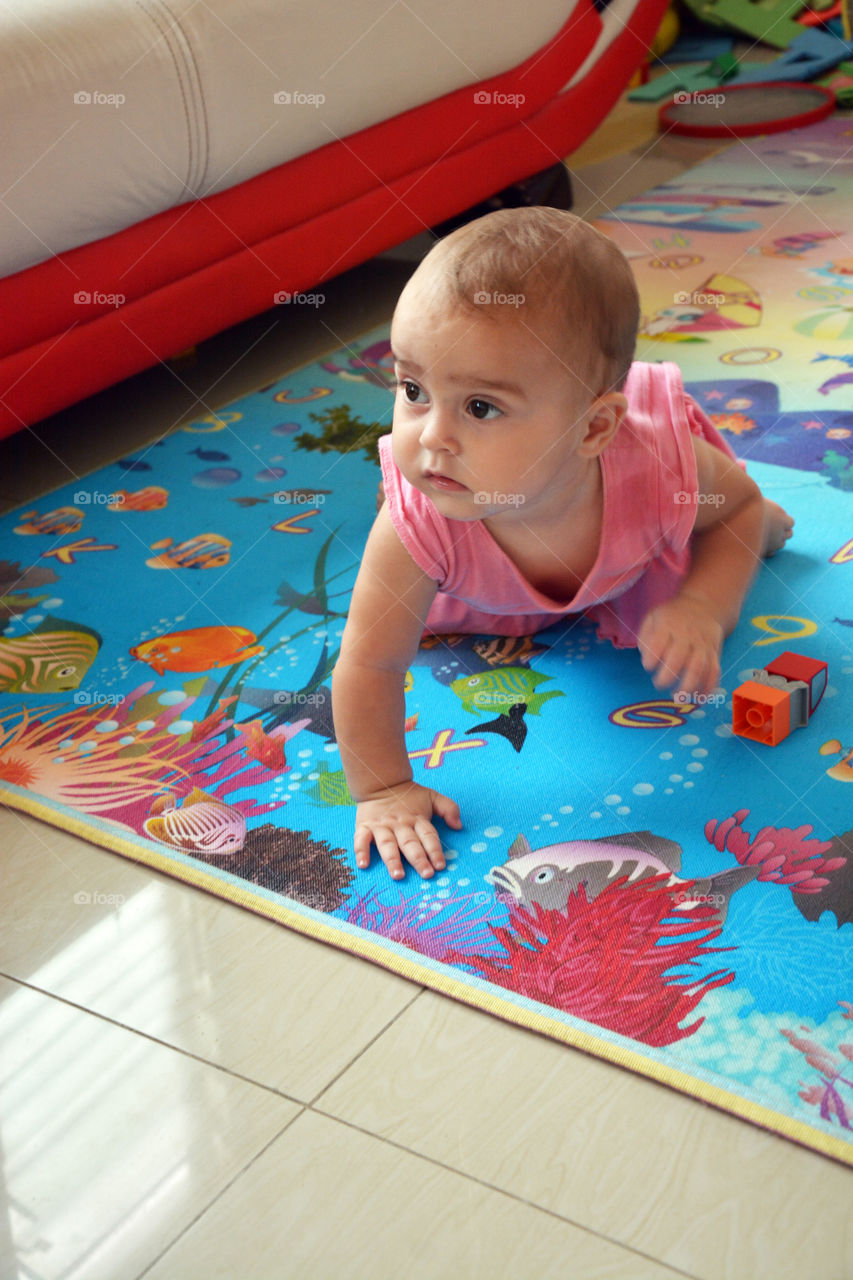 cute baby exploring house. baby girl crawling indoors