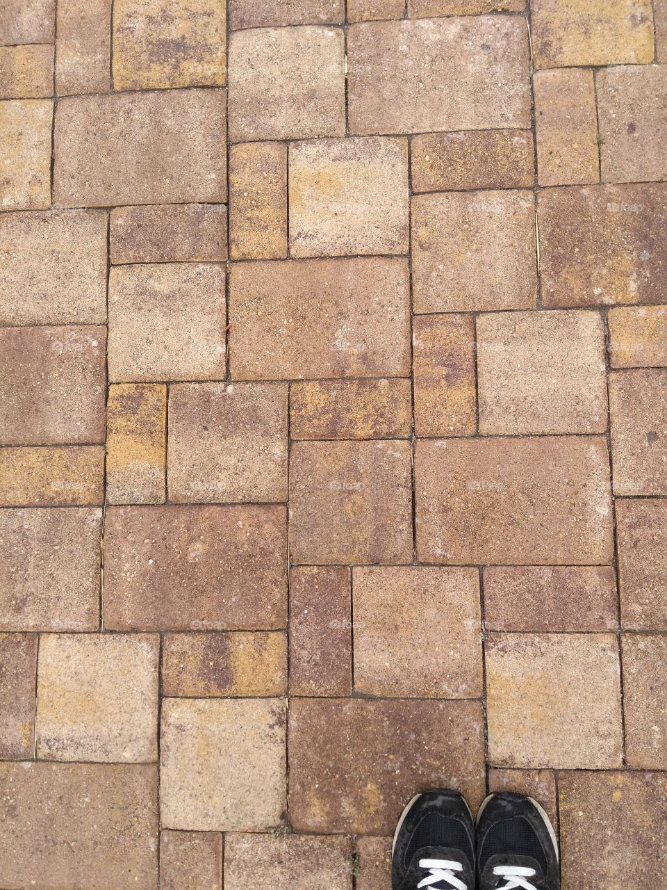 stones street pavement texture top view background and shoes