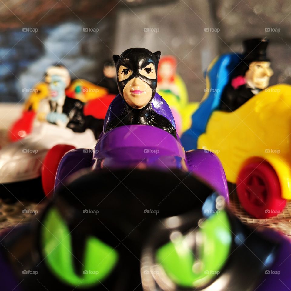 vintage McDonald's happy meal kids toys Catwoman and her crew from the 90s . Catwoman in top push car close up with background including penguin, two face, posing ivy and Robin.