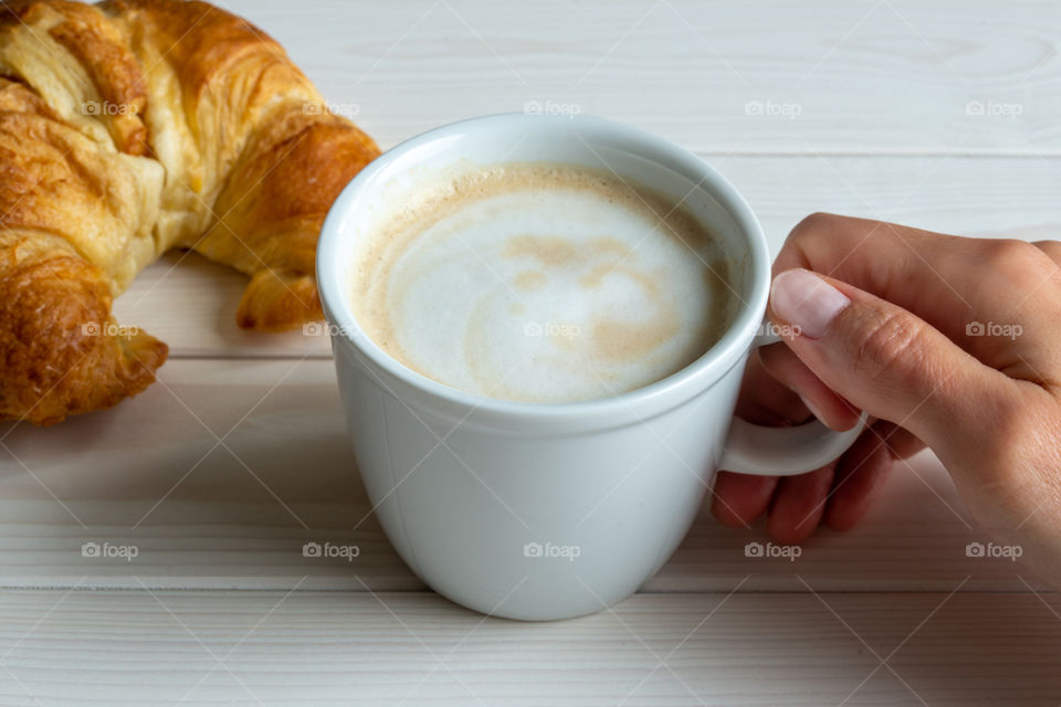 hand holding cup of coffee