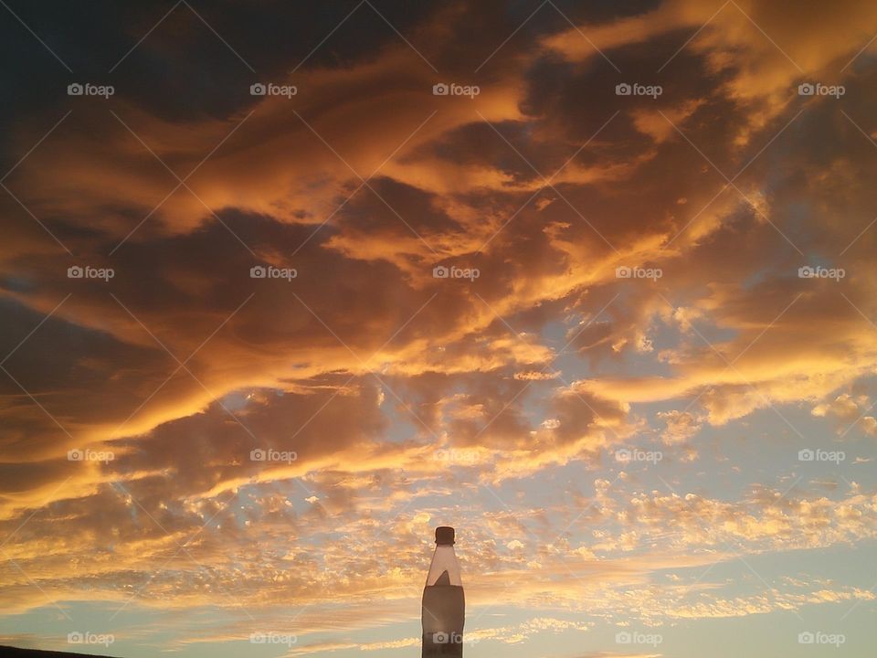 Scenic sky and a bottle embraces high sky.