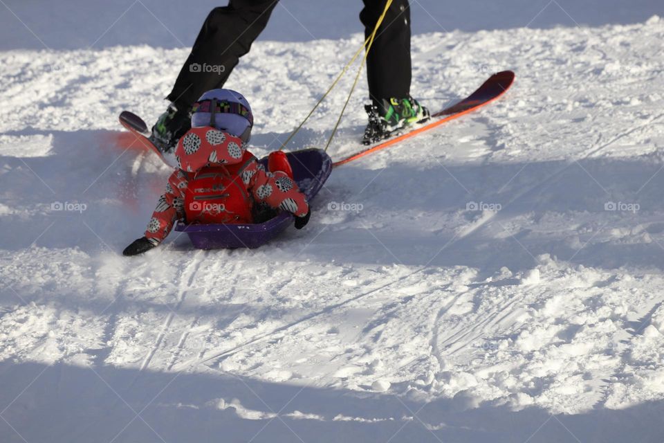 Man with ski pulling a slide 