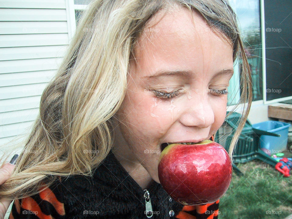 Big Apple - playing bobbing for apples game . 