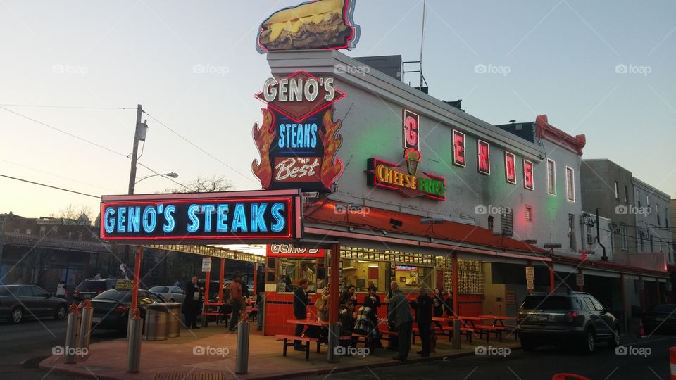 Geno's Steaks. At the corner where Philly cheesesteaks were born, it's Geno's!