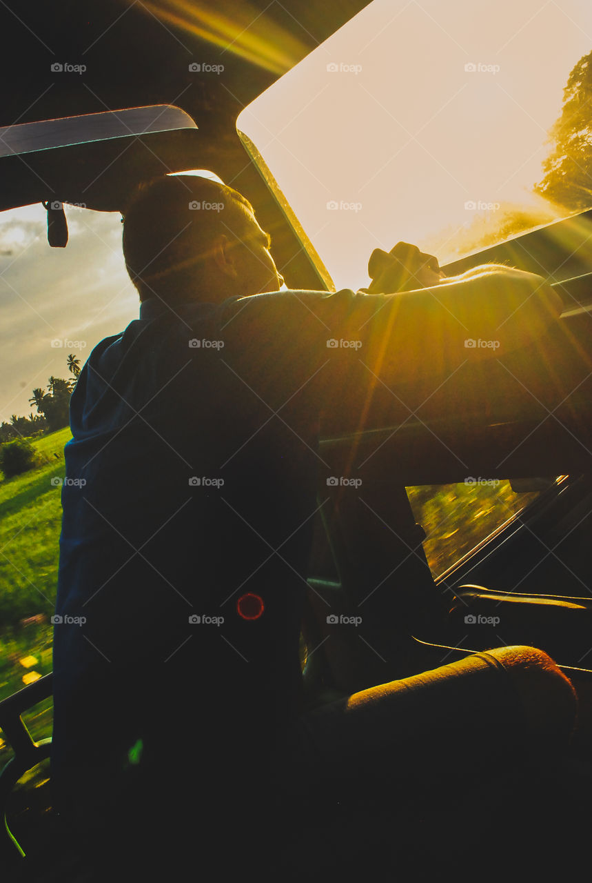 Man in the safari car watching sunset