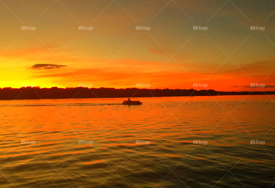 Silhouette of boat on idyllic lake