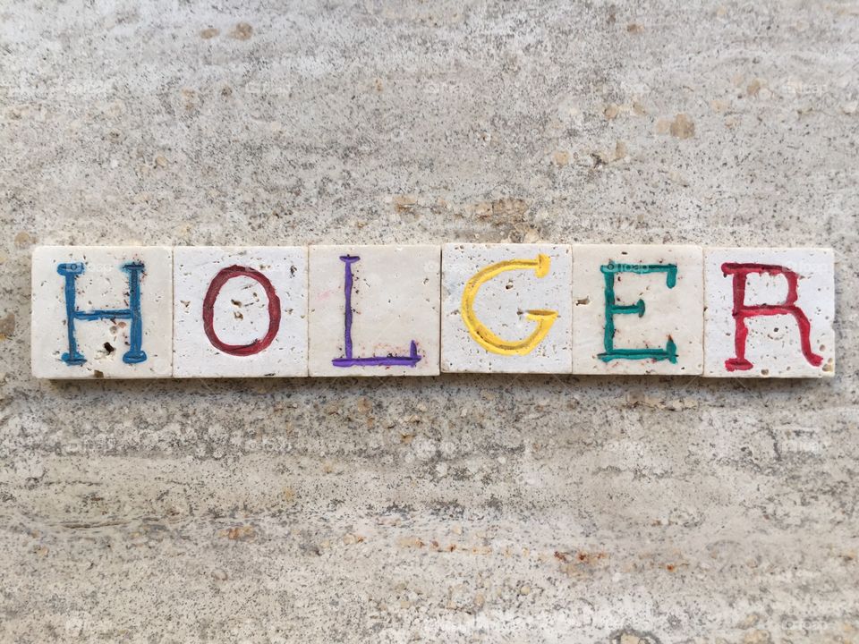 Holger, swedish male name . Composition with carved travertine pieces of Holger, swedish masculine name