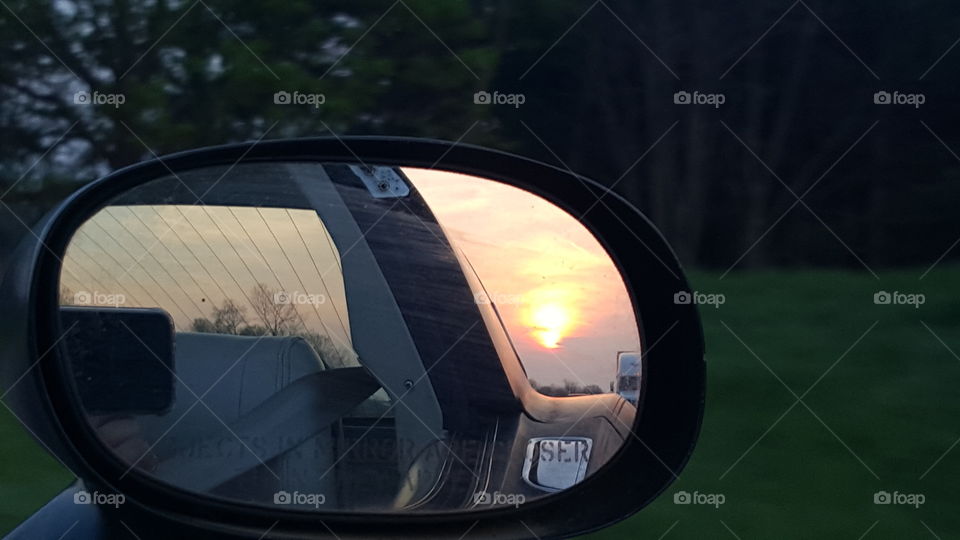 Sunset behind us . seeing the sunset in the rearview mirror