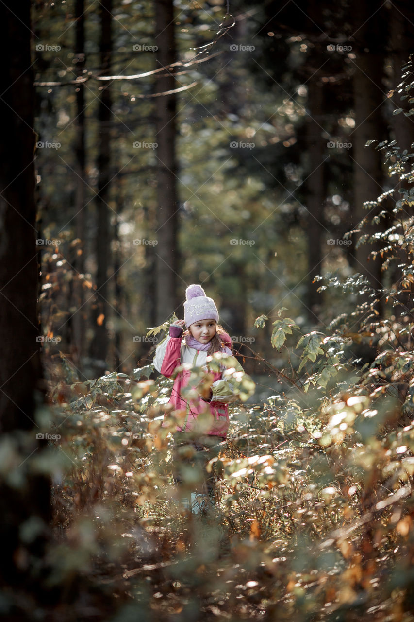 Little girl portrait in a rainy autumn day 