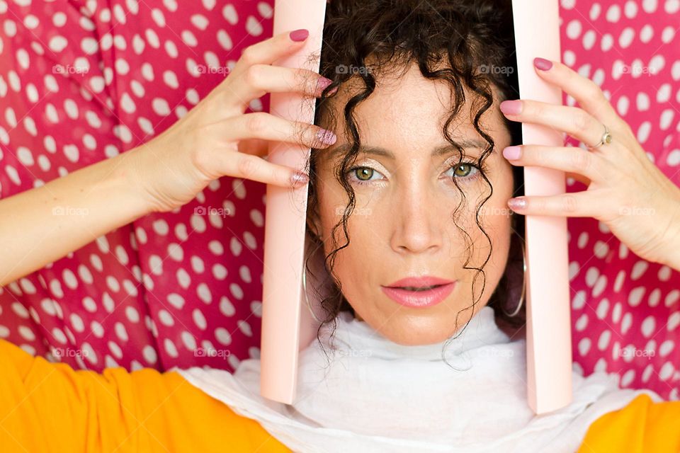 Portrait of a woman on pink background