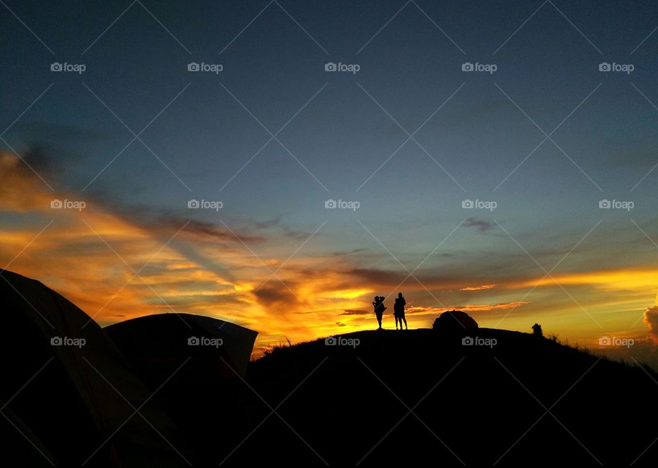 Silhouette of hikers at sunrise