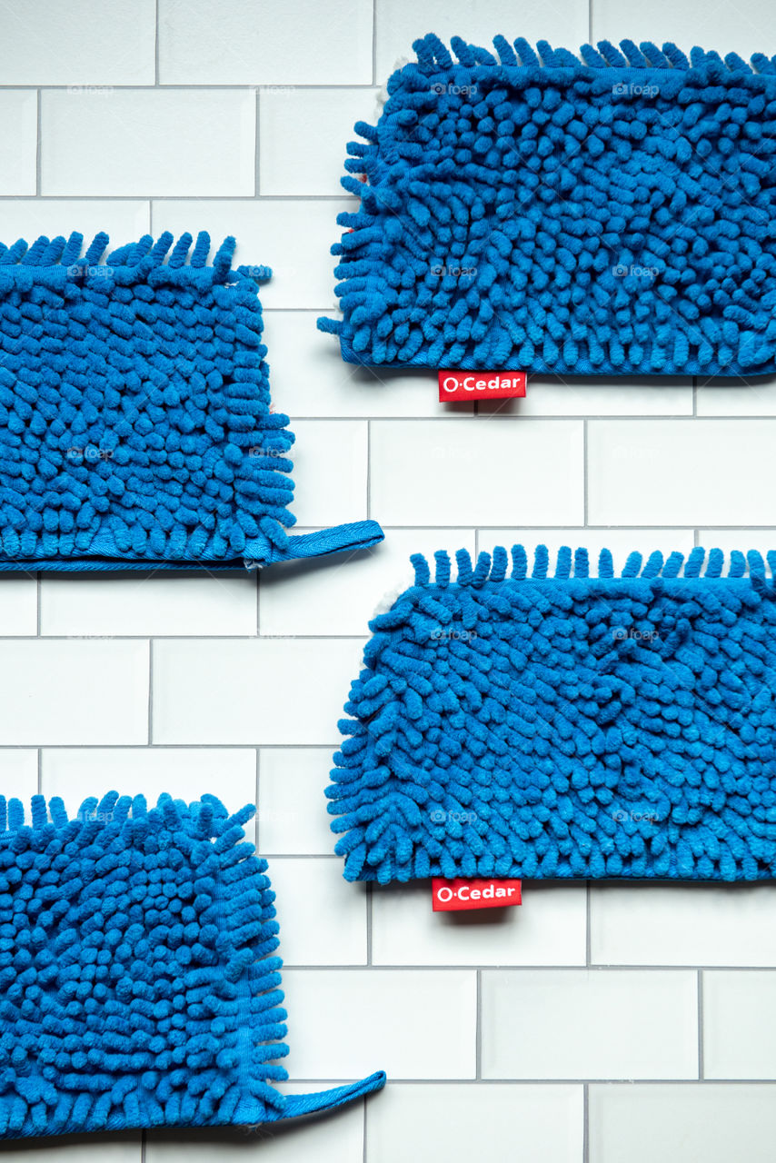 Flat lay of O-Cedar microfiber mop head refills on a tile floor