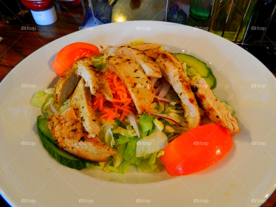 Succulent grilled chicken over a bed of fresh garden vegetables! Lettuce,shredded carrots,cucumbers,radish slivers and juicy tomatoes! So healthy and nutritional!