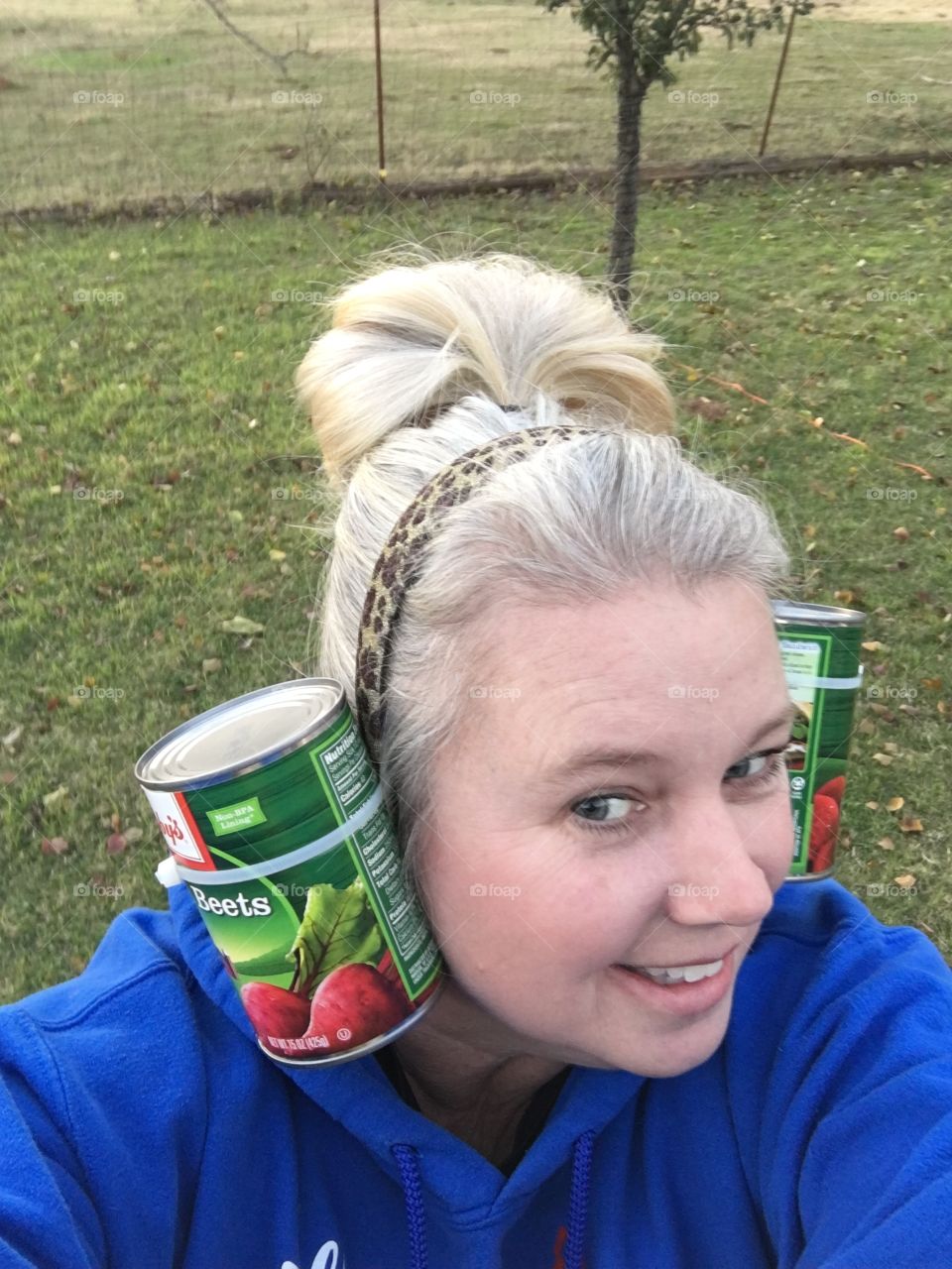 Portrait of smiling woman with tin can