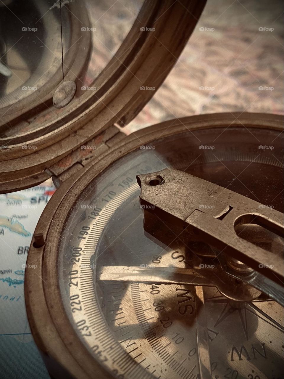 The anticipation of discovering new treasures and wonders on a travel adventure to destinations unknown. Compass and map.