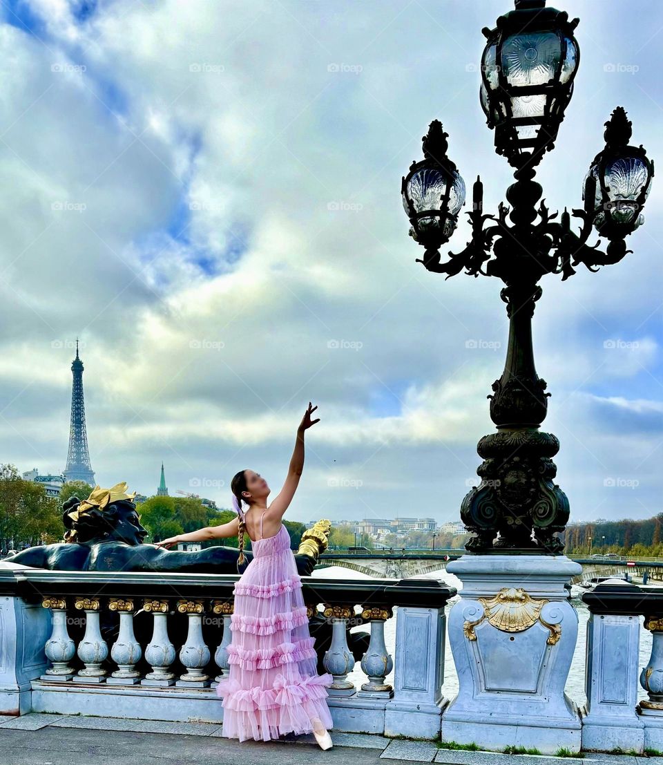 The Eiffel Tower and a ballerina all from the the famous the Pont Alexandre III bridge that spans the Seine in Paris.