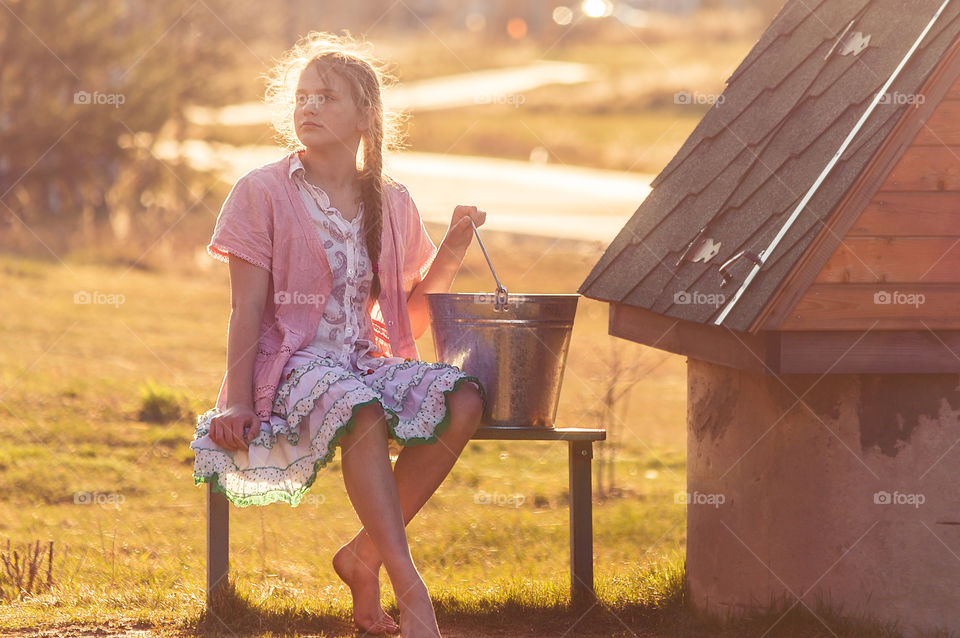 Girl near the draw-well