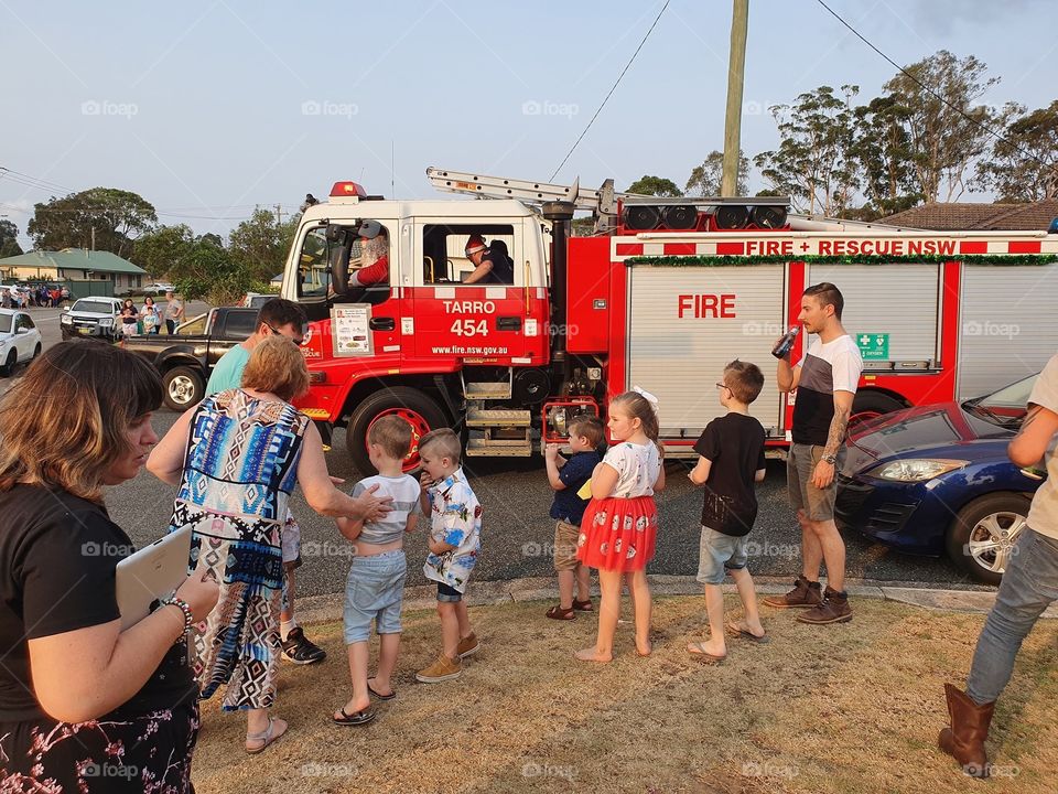 Santa in firetruck handing out lollies/candy