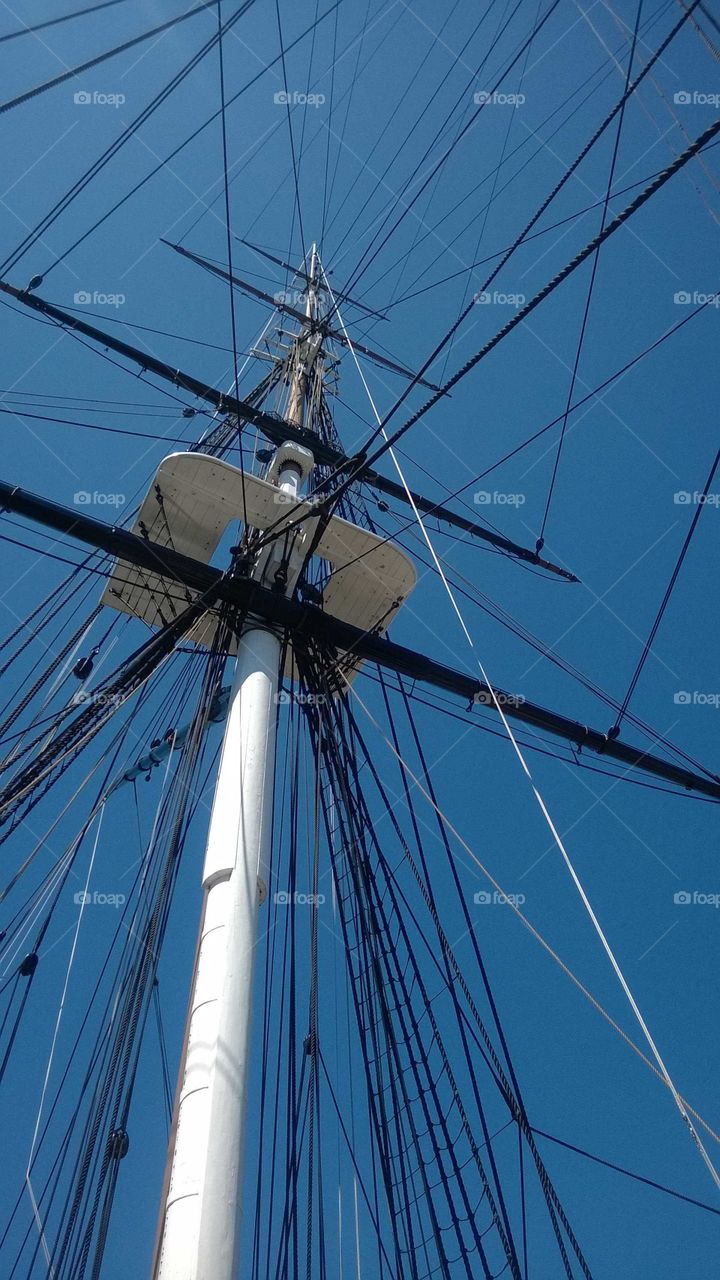 Ship rigging against a blue sky