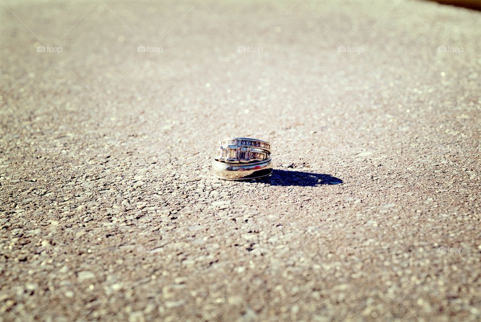 His and her wedding rings stand as one.