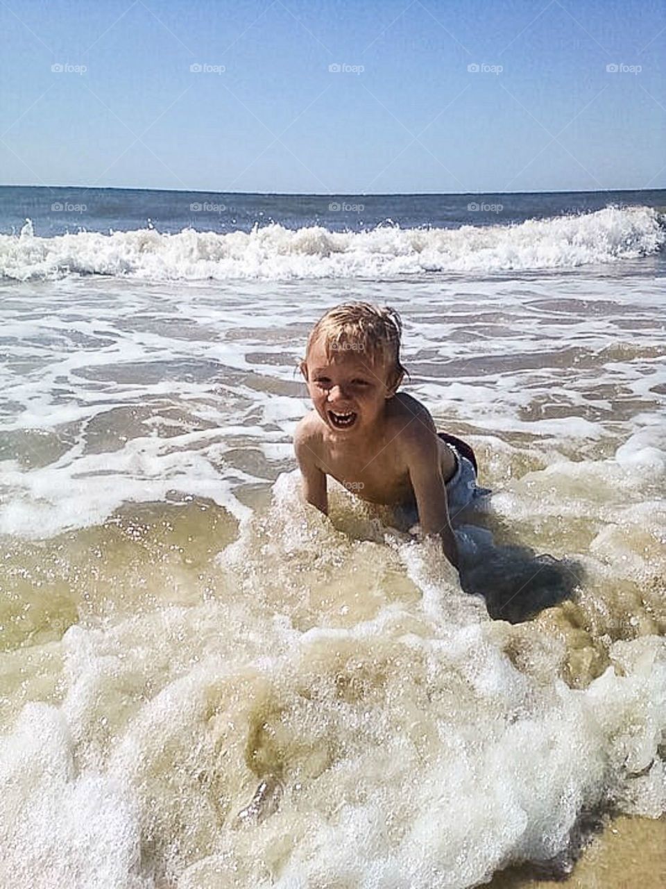 Boy bathing in sea