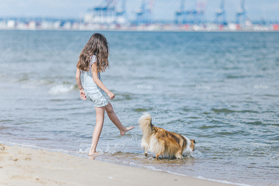 dog and girl on the beach