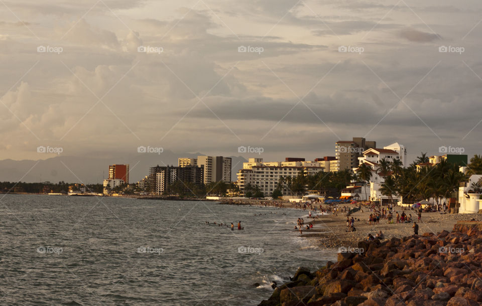 A northern view of the Malecon and Puerto Vallarta at sunset in summer.