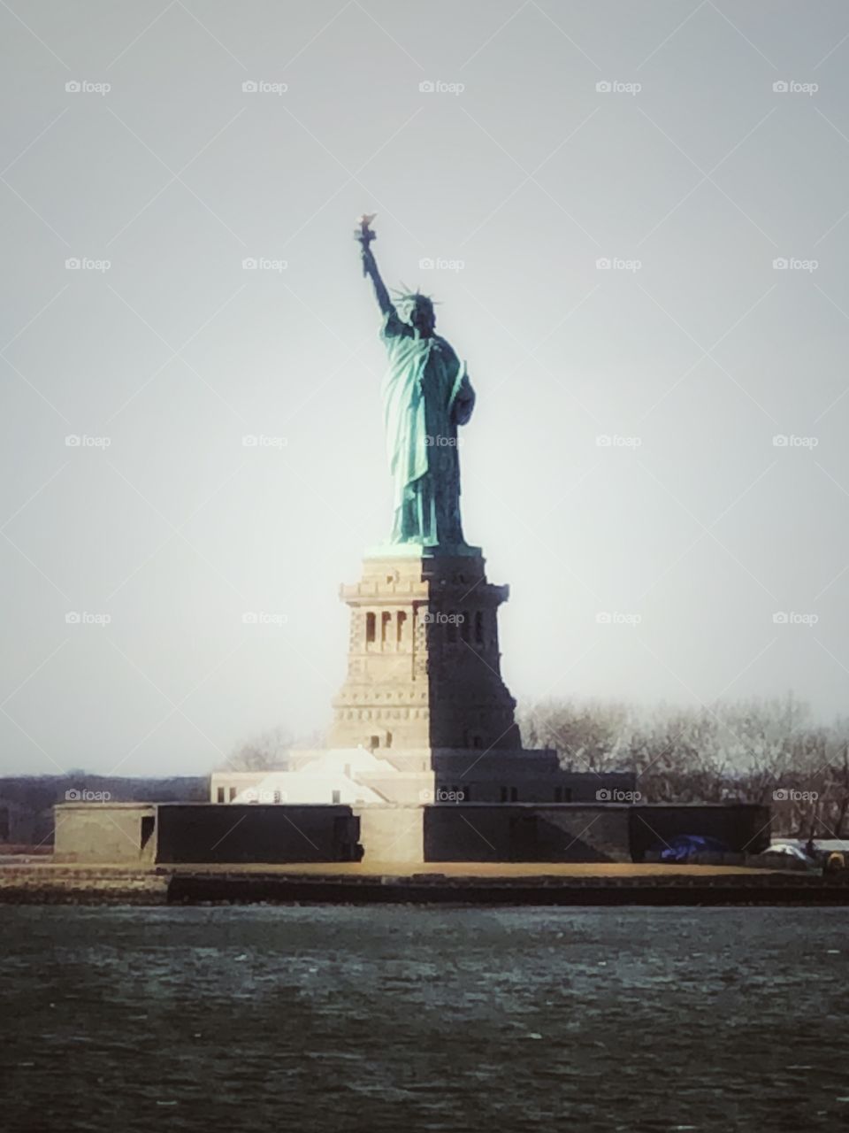 Statue of Liberty, the Lady Liberty, seen from the ferry in a winter day, with no visitors.