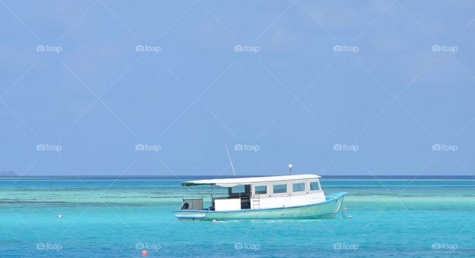 Lonesome boat in Sumatra. Aqua blue . 