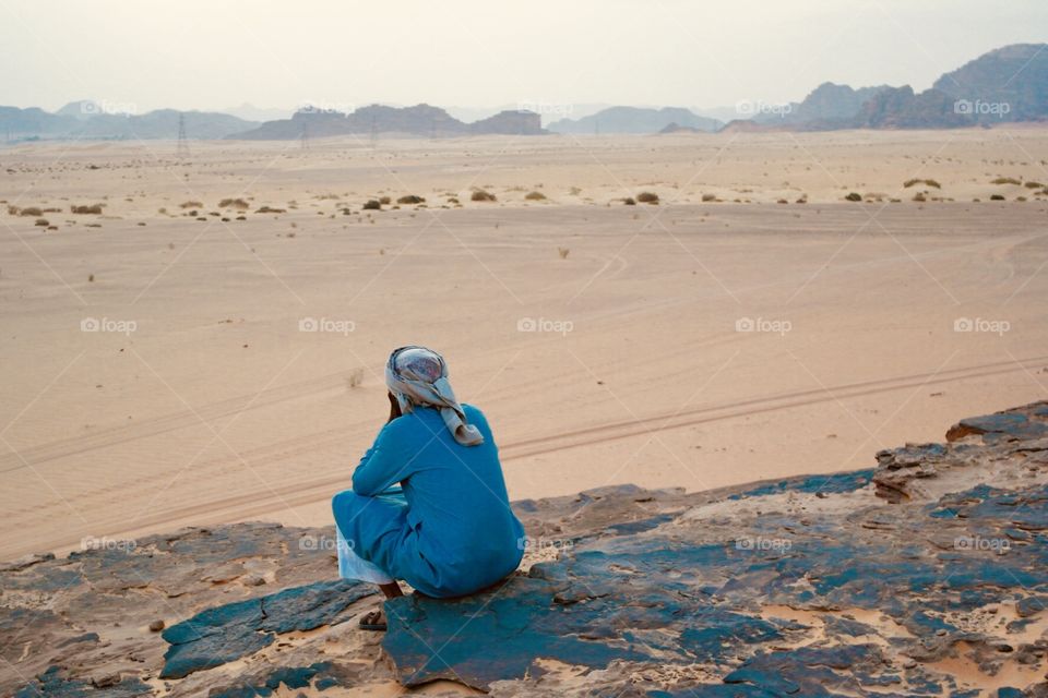 A beduin sitting on the desert