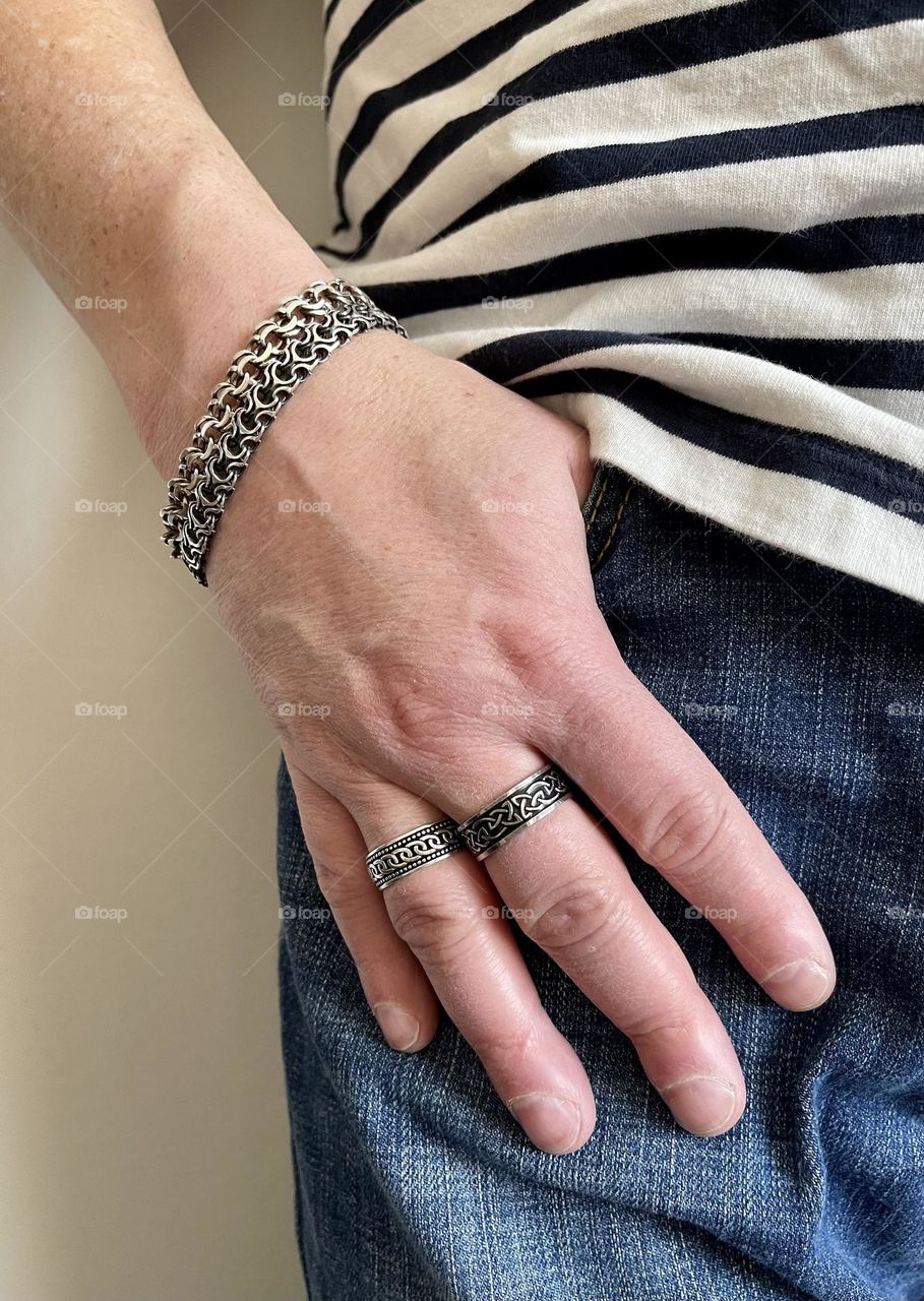 Male hand with silver rings and bracelets 